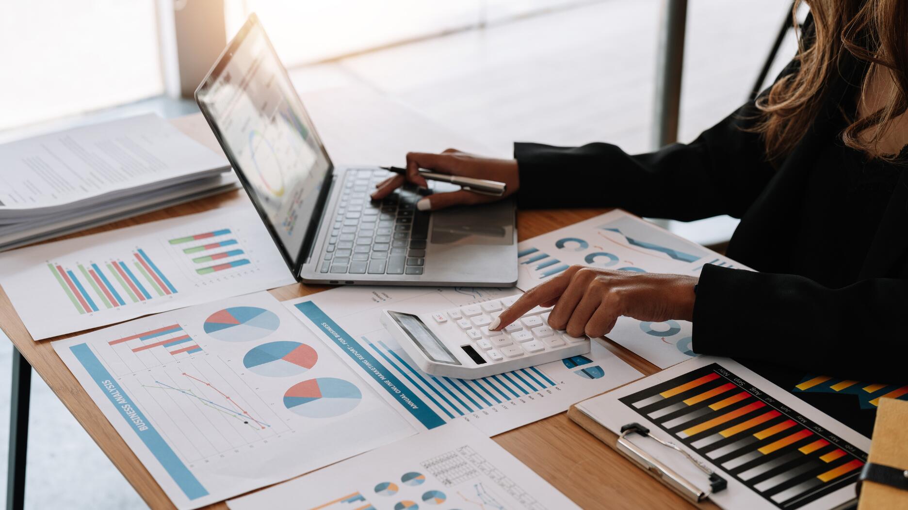 Stock image of woman on laptop with charts